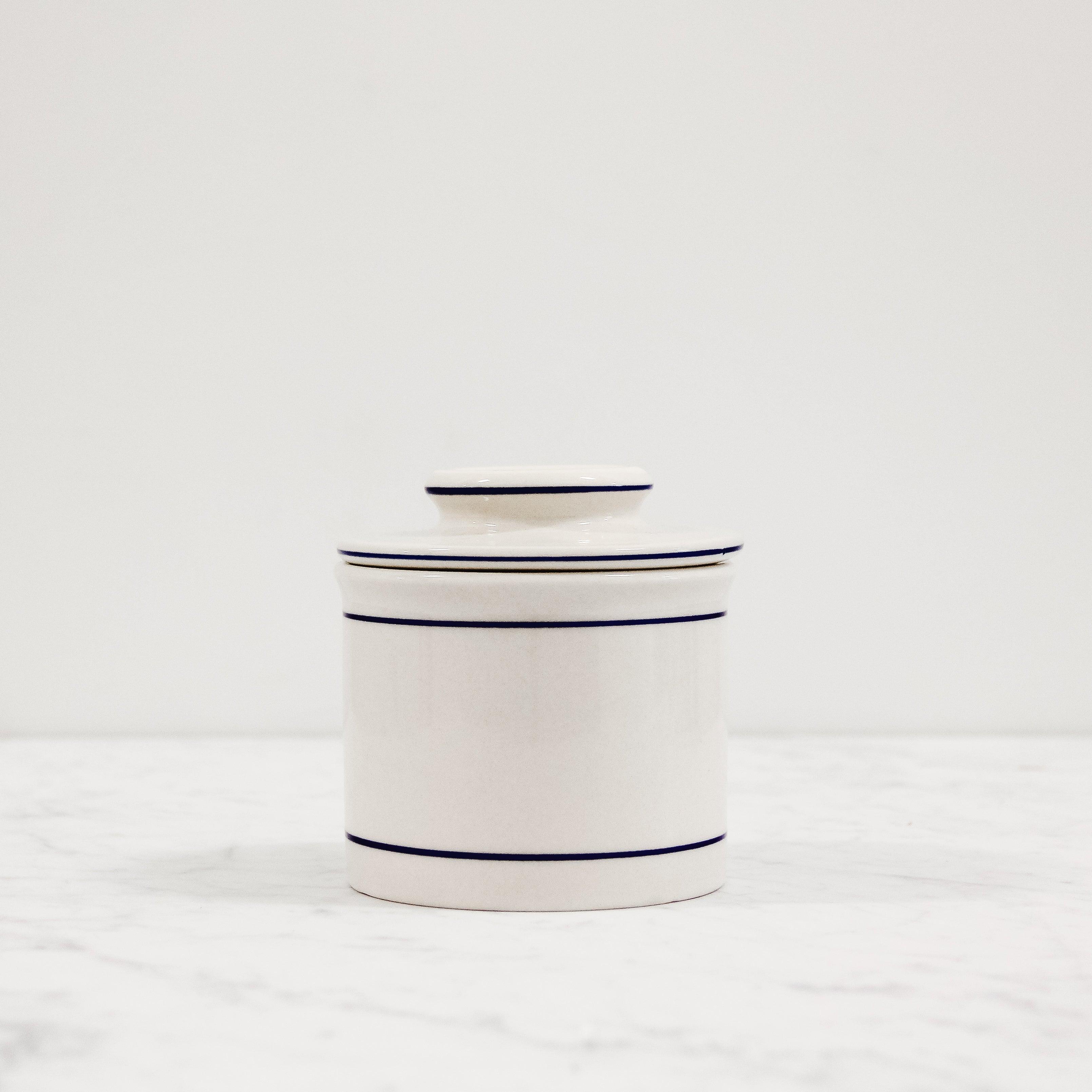 white ceramic butter crock with blue trim