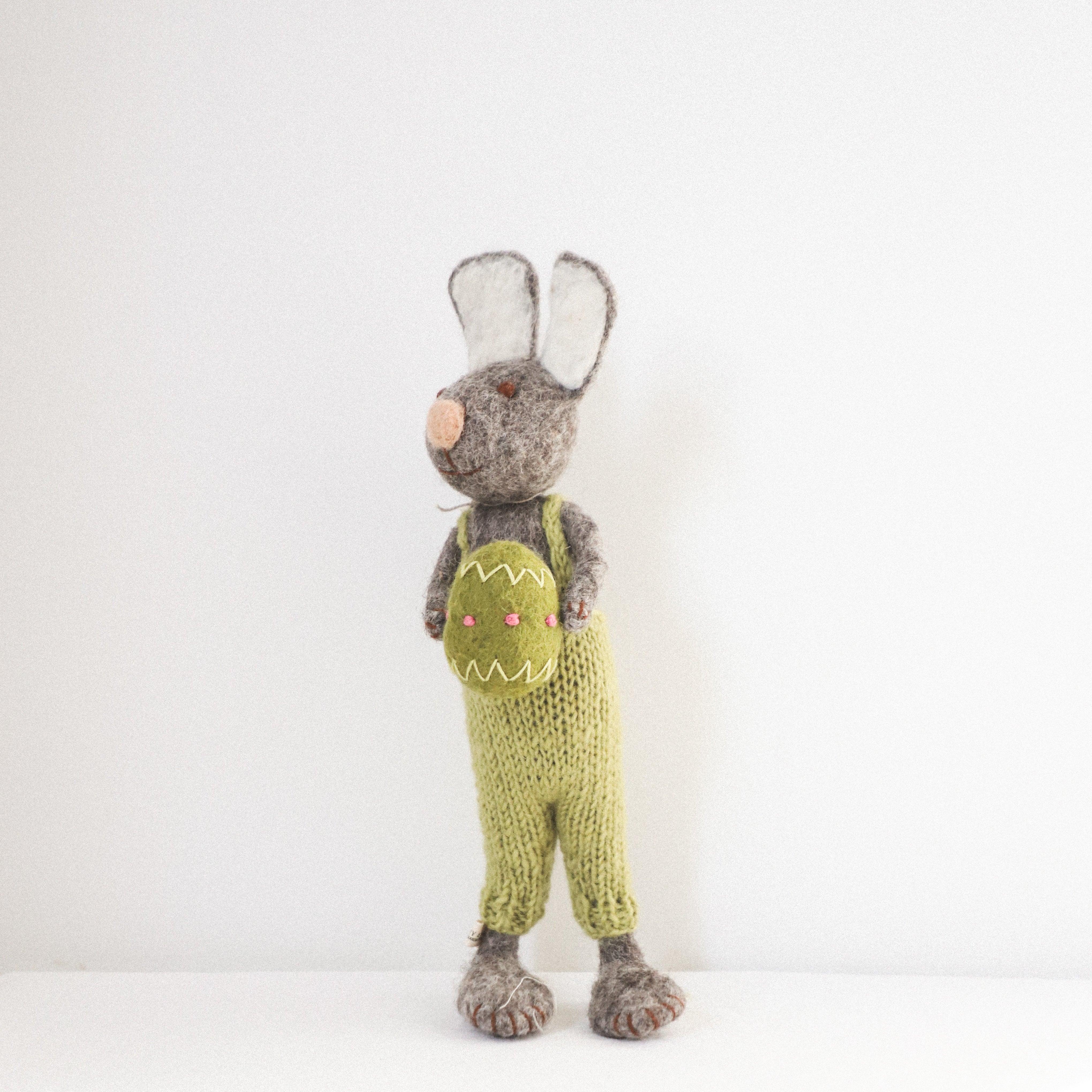 The Grace & Company Scandi - Woolly Bunny in gray and green knit overalls stands against a plain white background.