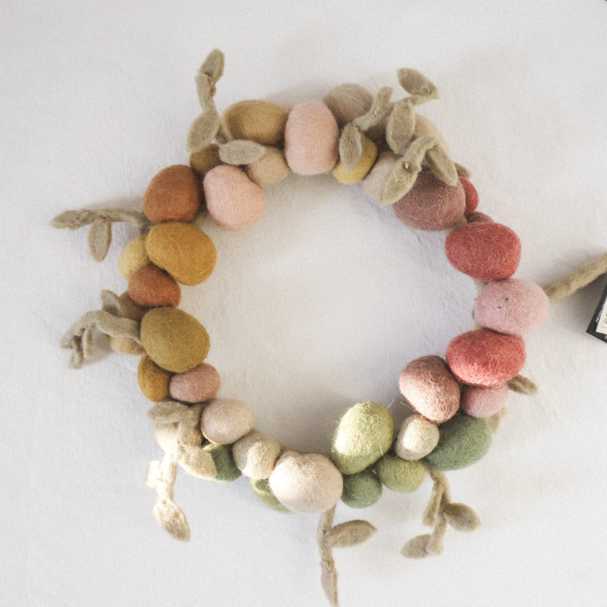 The Scandi - Easter Egg Felted Wreath by Grace and Company Ltd features pastel felted balls and leaves.