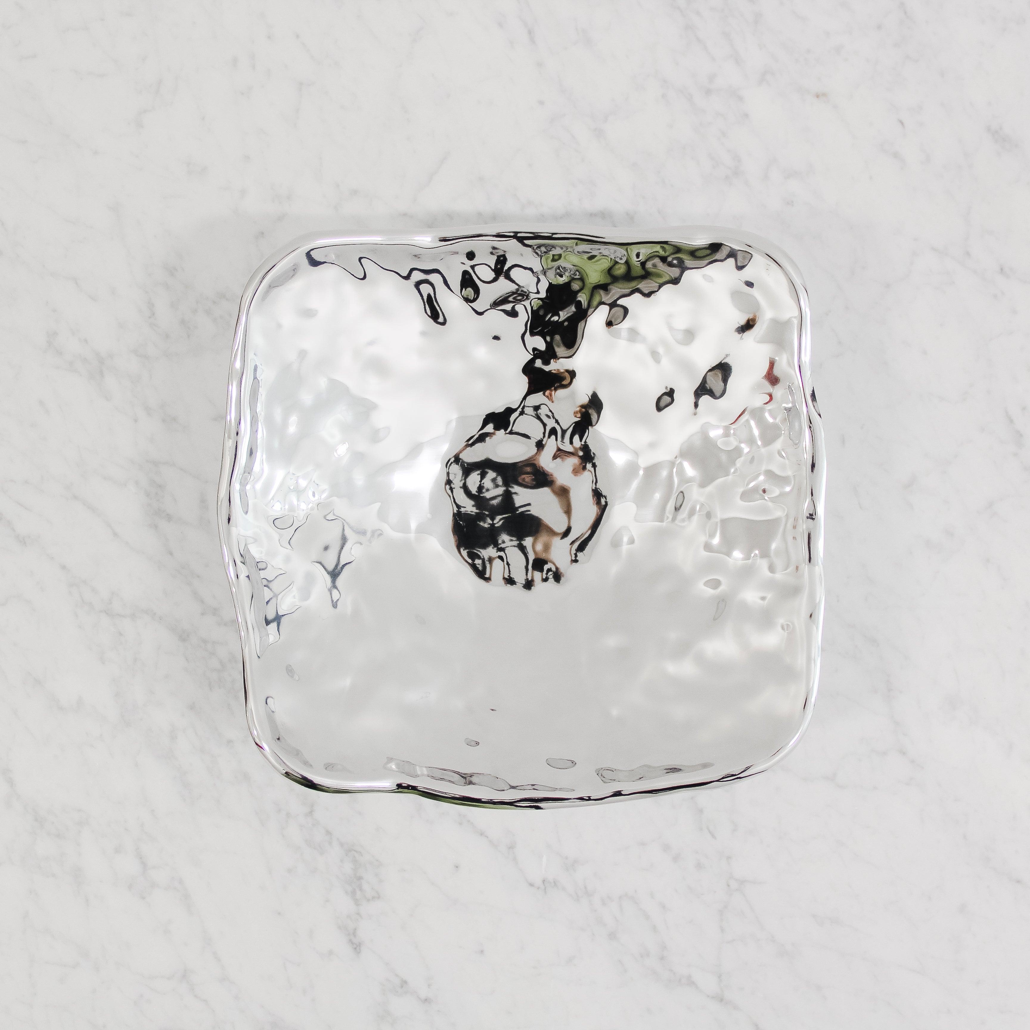 The Beatriz Ball SoHo Jena Bowl (Medium) by Grace & Company ltd: a shiny silver, square bowl with a wavy surface.
