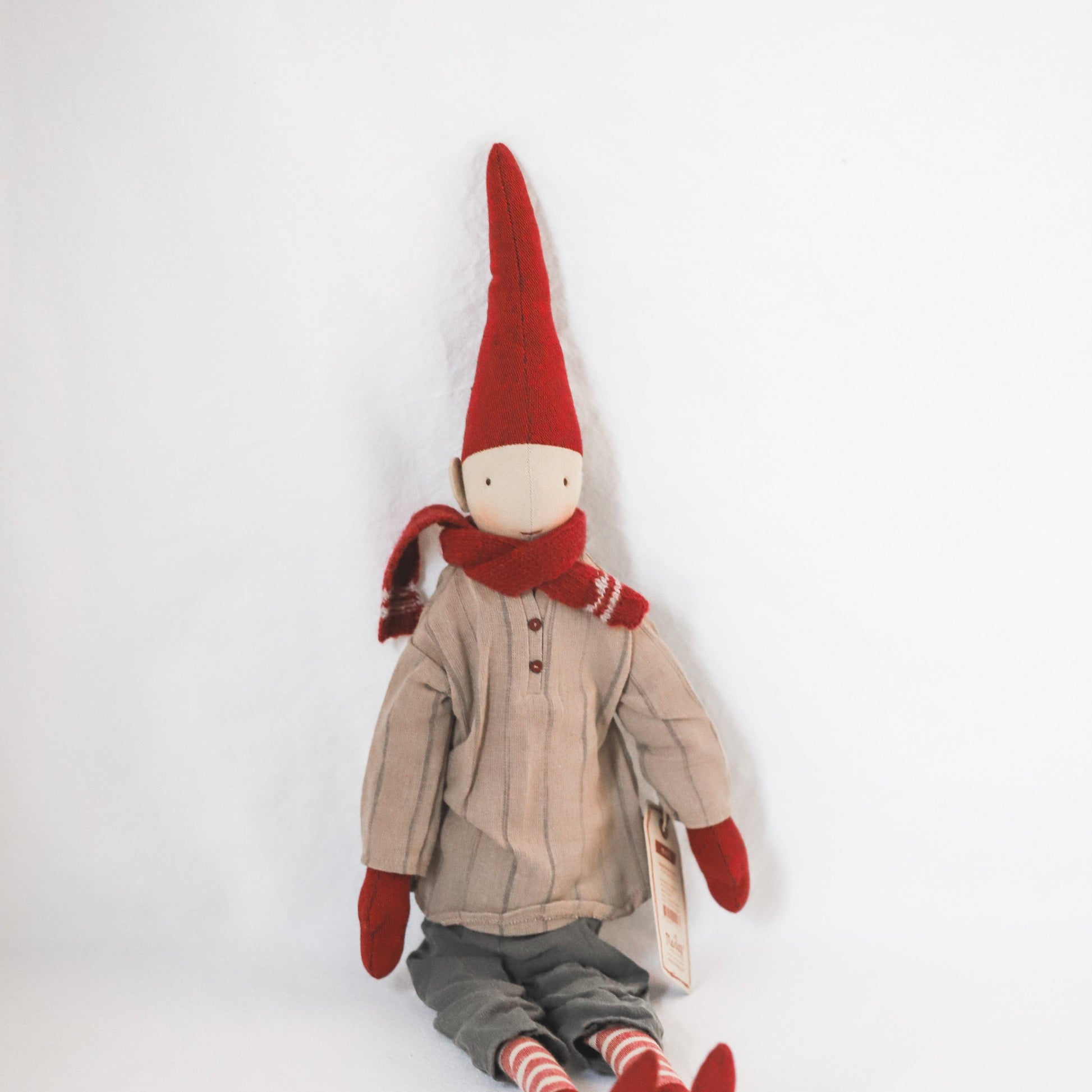 Maileg - Pixy Collection Christmas doll by Grace & Company with red hat, mittens, scarf, beige shirt, and gray pants.