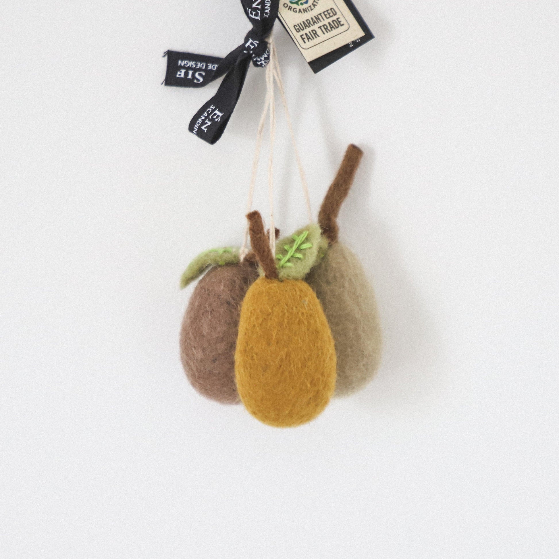 The Scandi Felted Pears Ornaments by Grace and Company Ltd feature three pears in brown, yellow, and beige with a tag.