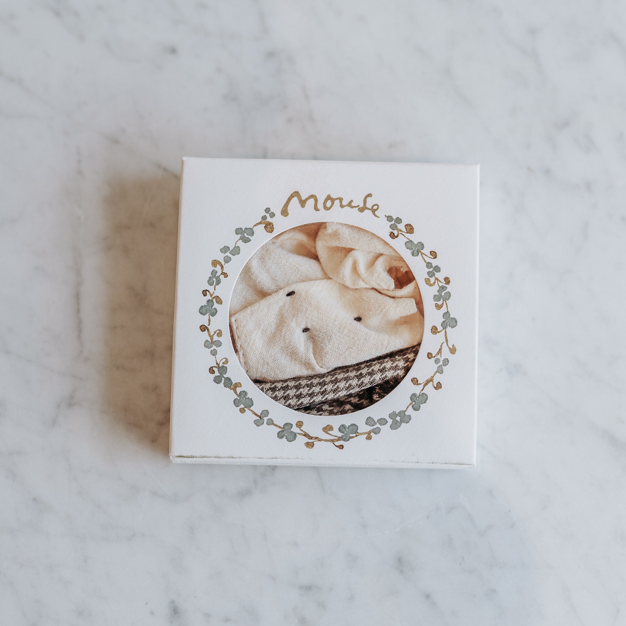 White box with circular window shows folded Maileg - Clothing for Mice by Grace & Company, leafy border, Mouh on top.