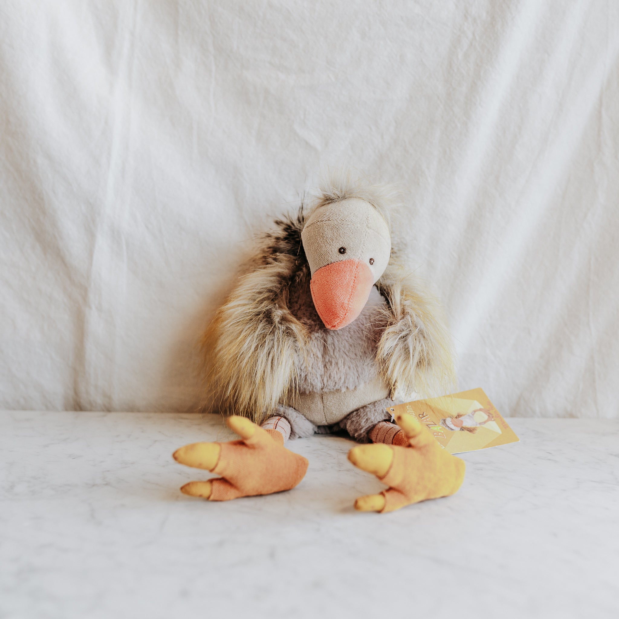 Moulin Roty - Bazar Gus The Vulture by Grace & Company ltd sits on a white surface with a tag attached.