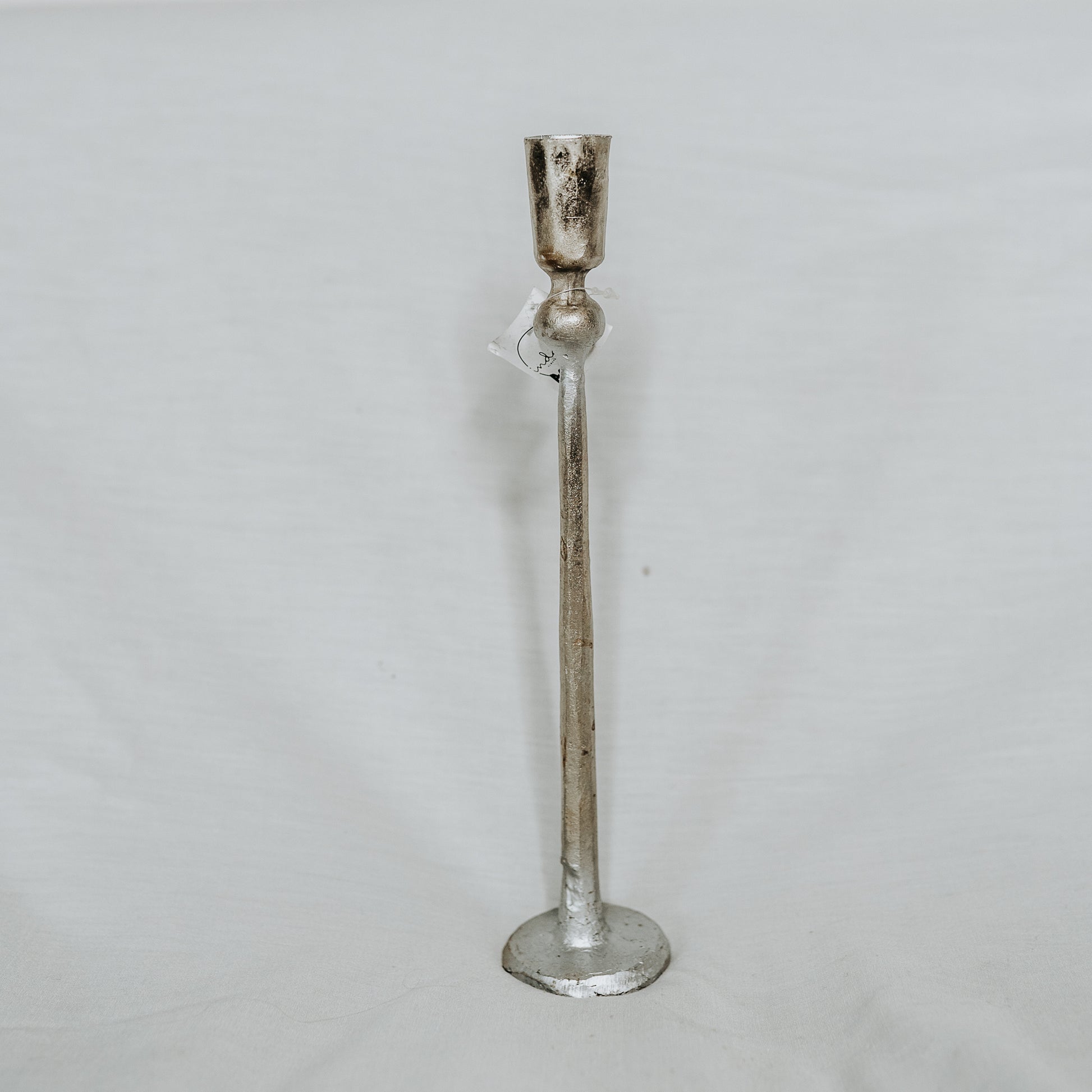 The Grace & Company Canmore Taper Candle Holder stands tall and slender on a plain white background.