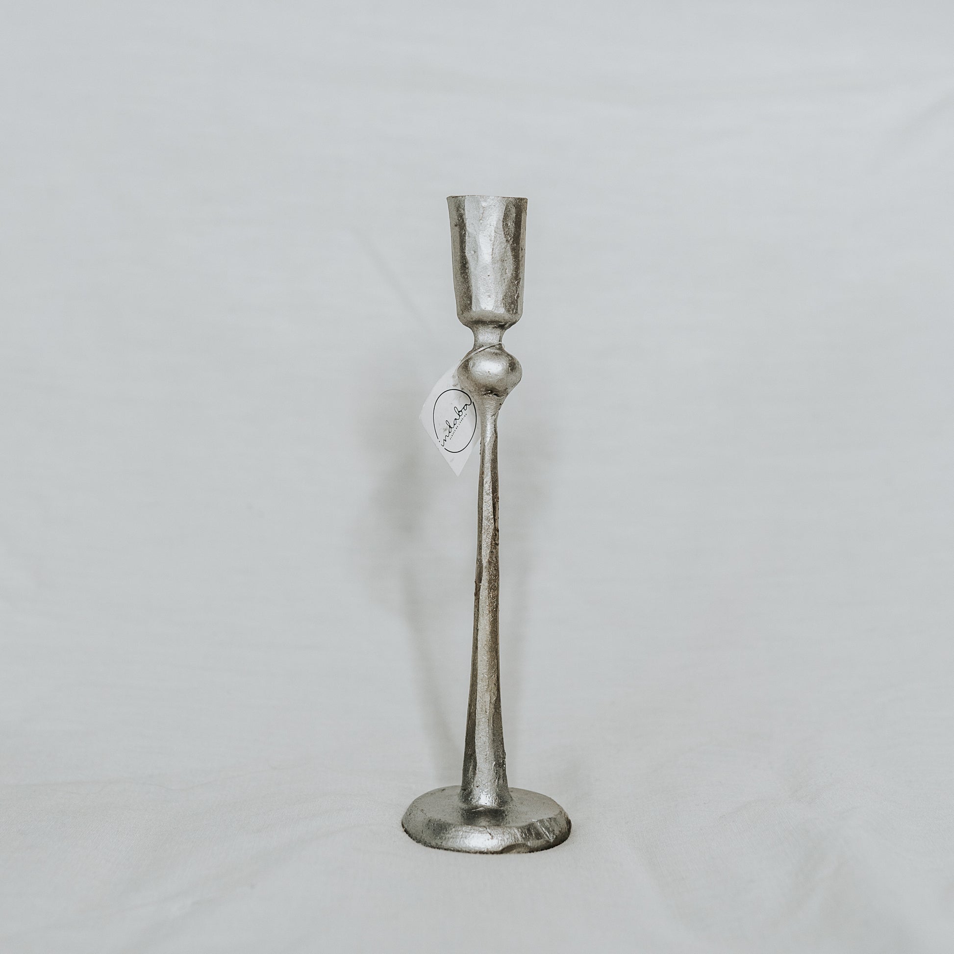 Grace & Company Canmore Taper Candle Holder in silver, shown with price tag on a plain white background.